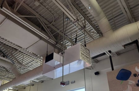 Commercial air filtration system removing chalk dust and airborne particulate from the air inside a climbing gym.