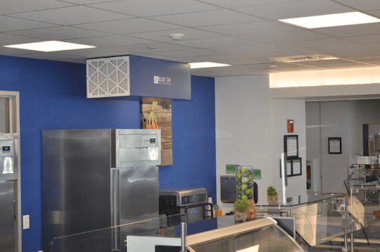 Quiet variable-speed CleanLeaf air cleaner operating unnoticed during lunch service in financial firm cafeteria.