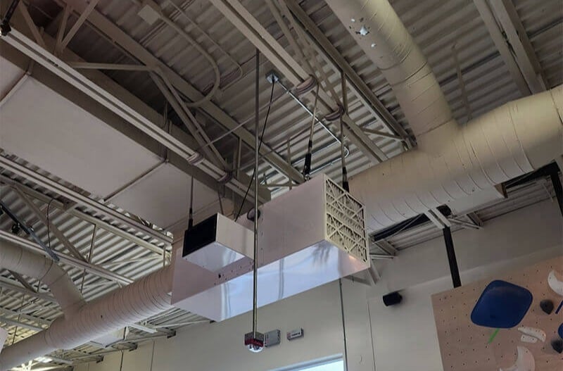 CleanLeaf air filtration system installed in a commercial climbing gym to control airborne chalk dust.