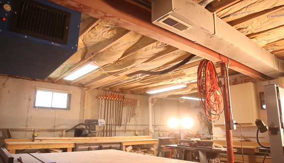 Basement woodshop producing fine custom built-ins with CleanLeaf OX1100 dust filtration system.